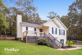 Newnan house for rent - a white house with a deck and a yard