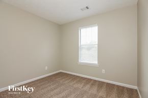 Newnan house for rent - a bedroom with a carpet and a window