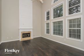 Mableton house for rent - A room with a fireplace and a window with blinds.