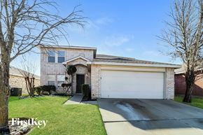 Fort Worth house for rent - A house with a garage and a driveway in front of it.
