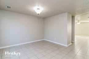 Fort Worth house for rent - A spacious empty room with a FirstKey Homes logo on the bottom left.