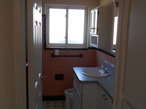 St. Clair Shores house for rent - A bathroom with a toilet, sink, and window.