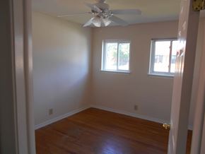 St. Clair Shores house for rent - A room with a ceiling fan and two windows.
