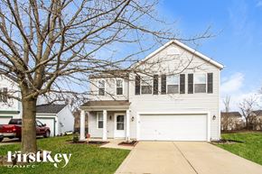 Indianapolis house for rent - A white house with a garage is shown in the image.