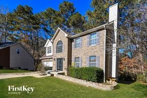 Snellville house for rent - the front of a brick house with a yard and grass