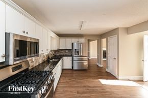 Snellville house for rent - a kitchen with stainless steel appliances and white cabinets