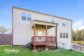 Auburn house for rent - the exterior of a white house with a porch and a deck