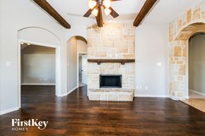 Princeton house for rent - a living room with a stone fireplace and wooden floors