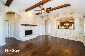 Princeton house for rent - a living room with a stone fireplace and wood floors