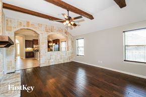 Princeton house for rent - an empty living room with wood floors and a ceiling fan