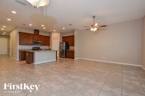 Apopka house for rent - A spacious kitchen with a refrigerator, microwave, and oven.