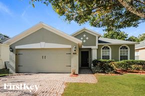 Orlando house for rent - a house with a garage door and a lawn