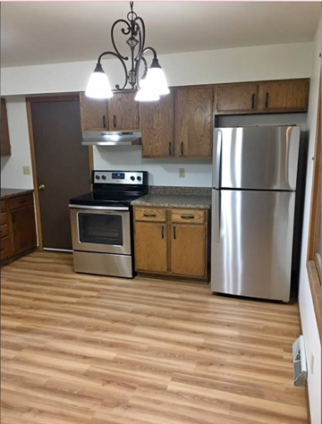 Schofield apartment for rent - a kitchen with stainless steel appliances and wooden floors