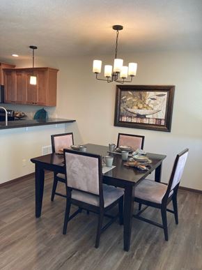 Lincoln house for rent - A dining room with a wooden table and chairs.