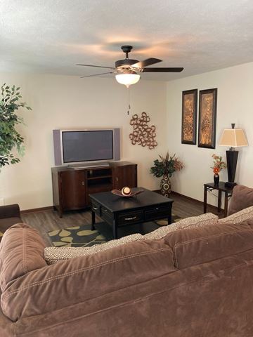 Lincoln house for rent - A living room with a brown couch and a television.