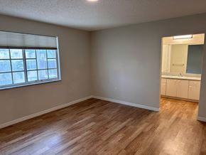 N. Miami apartment for rent - an empty living room with wood flooring and a window