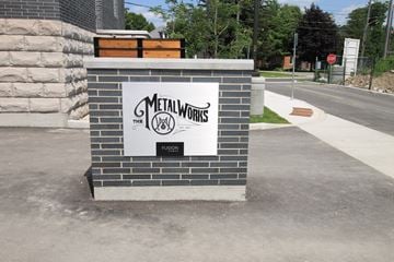 Guelph apartment for rent - a monument sign on the side of a sidewalk