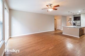 Moncks Corner house for rent - A spacious room with wooden floors and a ceiling fan.
