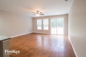 Moncks Corner house for rent - A room with wooden floors and a ceiling fan.