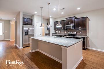 Moncks Corner house for rent - A modern kitchen with a granite countertop and stainless steel appliances.