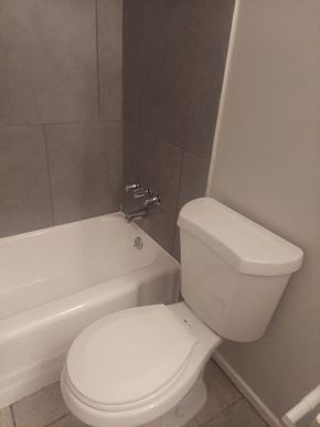 San Bernardino apartment for rent - a bathroom with a white toilet and a bath tub