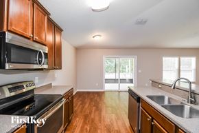 Jacksonville house for rent - A kitchen with wooden cabinets and stainless steel appliances.