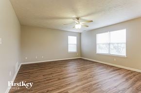 Indianapolis house for rent - the spacious living room with hardwood flooring and a ceiling fan
