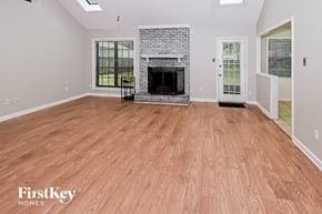 Bartlett house for rent - the living room has a fireplace and a wooden floor