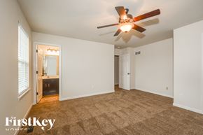 Lake St Louis house for rent - A spacious room with a ceiling fan and carpeted floor.