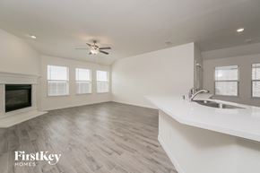 Princeton house for rent - a kitchen and living room with a sink and a fireplace