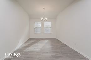 Princeton house for rent - an empty room with a chandelier and two windows