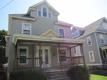 Syracuse apartment for rent - the front of a house with stairs and a porch