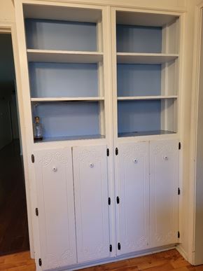 Temple house for rent - a cupboard with white doors and shelves with blue doors
