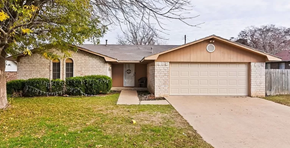 Temple house for rent - a white brick house with a white garage door
