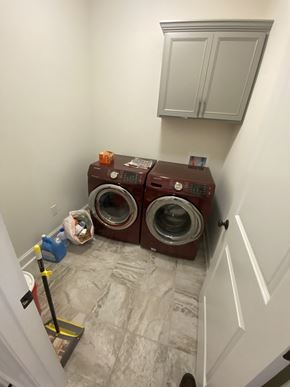 Maurice house for rent - a washer and dryer in a small laundry room