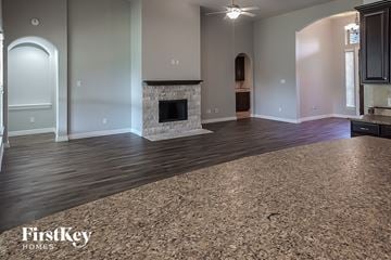 Fulshear house for rent - a living room with a rug and a fireplace