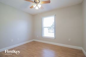 Cocoa house for rent - a living room with wood floors and a ceiling fan