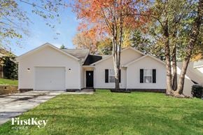 Charlotte house for rent - a white house with a lawn and trees