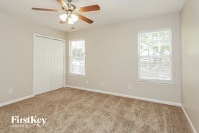 Charlotte house for rent - a bedroom with carpet and a ceiling fan