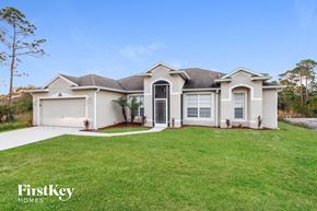Palm Bay house for rent - a white house with a lawn in front of it