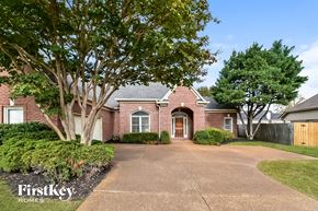 Cordova house for rent - A brick house with a driveway in front of it.