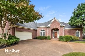 Cordova house for rent - A brick house with a garage door is for sale.