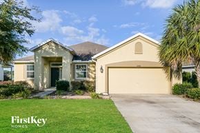 Green Cove Springs house for rent - a beige house with a driveway and a garage door