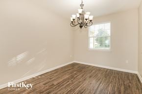 Green Cove Springs house for rent - the dining room of a home with wood flooring and a chandelier