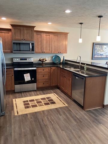 Lincoln house for rent - a kitchen with wooden cabinets and stainless steel appliances