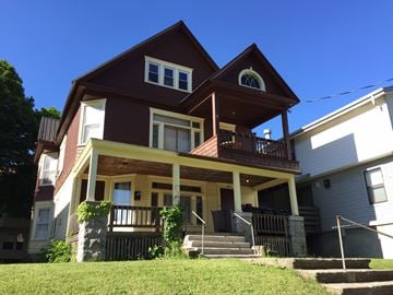 Syracuse apartment for rent - a house with a porch on a sunny day