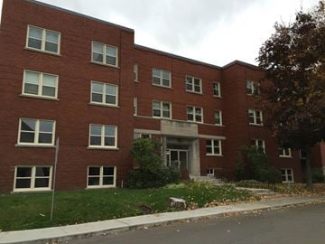 Ottawa apartment for rent - a red brick building with a sidewalk in front of it