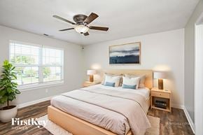 Bargersville house for rent - A bedroom with a bed, a ceiling fan, and a painting on the wall.
