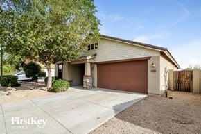 Buckeye house for rent - A house with a brown garage door is for sale.