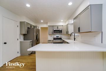 Dublin house for rent - A kitchen with a white counter top and cabinets.